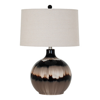 image cut out on white background of brown glass lamp with linen shade