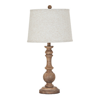 image cut out on white background of brown table lamp with edged linen shade