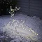 image of single reindeer stake light lit up outside a house in the snow at night