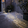 set of 3 reindeer shape with warm white LEDs stakes in ground outside a house at night
