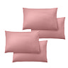 4 pillows with coral pink pillowcases, image cut out on white background