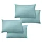 image cut out on white background of four duck egg blue pillowcases over pillows