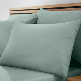 set of 4 light green pillowcases on bed with matching fitted sheet