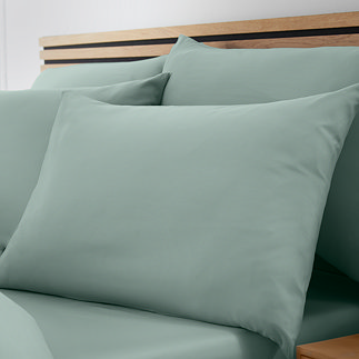 set of 4 light green pillowcases on bed with matching fitted sheet