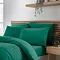 4 pillows with teal green pillowcases on bed