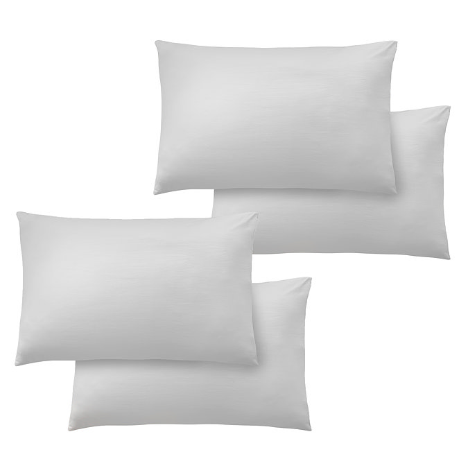 image cut out on plain background of four white pillowcases in two pairs