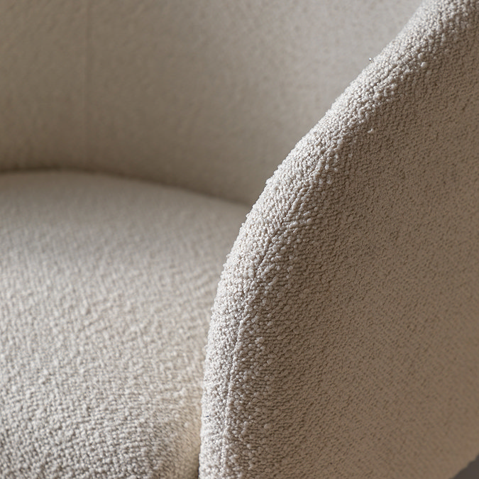 close up image of curved arm of faux sheepskin tub chair