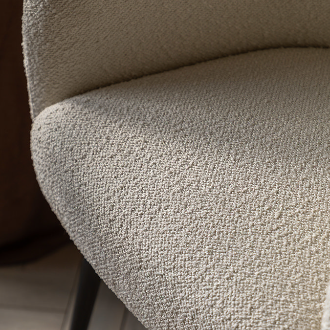 close up on faux sheepskin seat of ivory accent chair