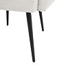 close up image of black metal legs of ivory accent chair