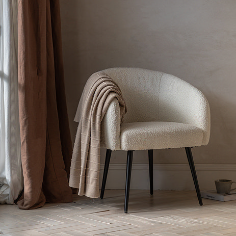image of faux sheepskin tub chair with sleek black legs