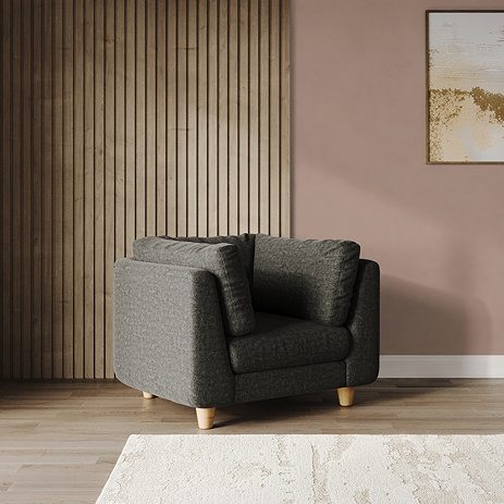 lifestyle image of chunky armchair in moleskin fabric with light beech legs