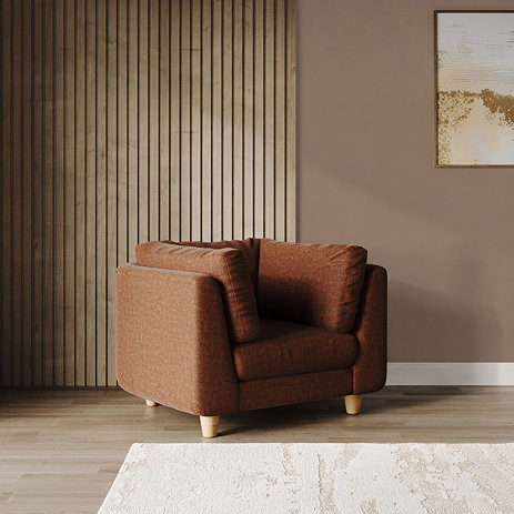 lifestyle image of chunky armchair in pumpkin fabric with light beech legs