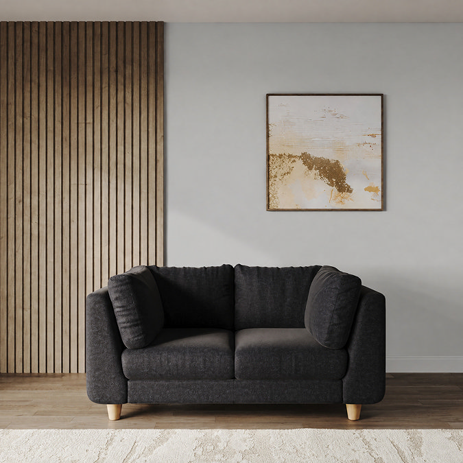lifestyle image of medium chunky sofa in indigo fabric with light beech legs