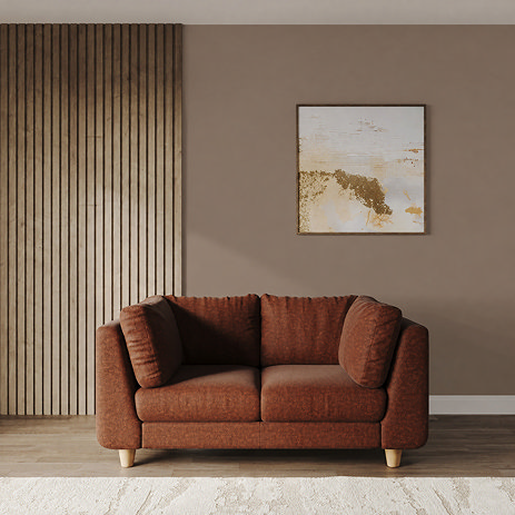 lifestyle image of medium chunky sofa in pumpkin with light beech legs