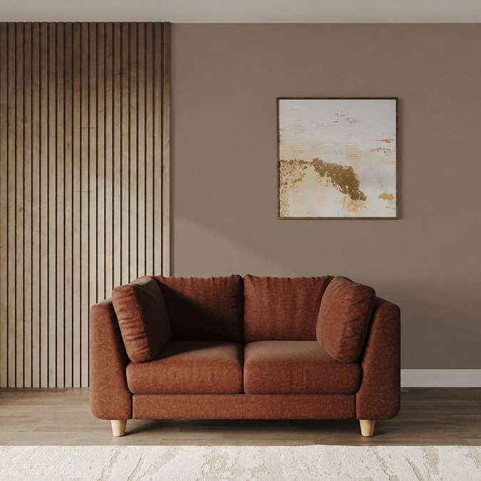 lifestyle image of medium chunky sofa in pumpkin with light beech legs