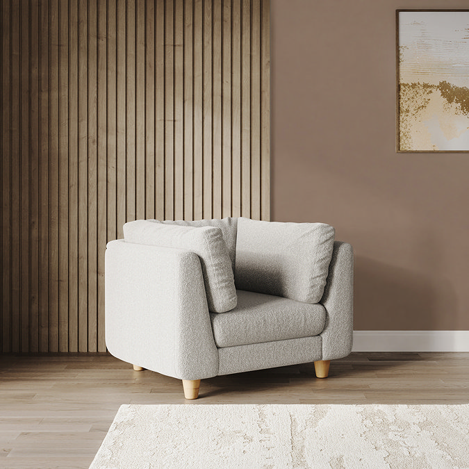lifestyle image of chunky cocoon boucle armchair with light beech legs