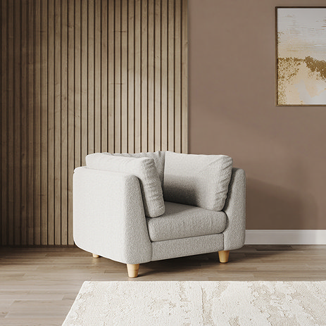 lifestyle image of chunky cocoon boucle armchair with light beech legs