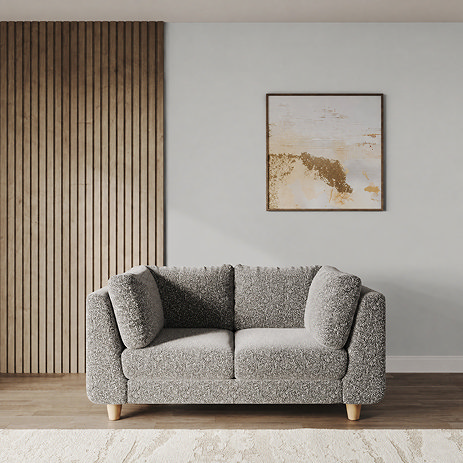lifestyle image of medium chunky sofa in mist boucle with light beech legs