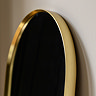 close up image on smooth rounded top of gold floor length mirror
