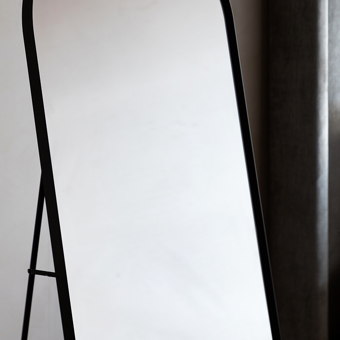 close up on mid section of black metal mirror