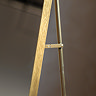close up image of where slim supportive stand attaches to gold floor mirror