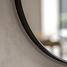 close up on smooth bottom edge of black pebble shaped mirror