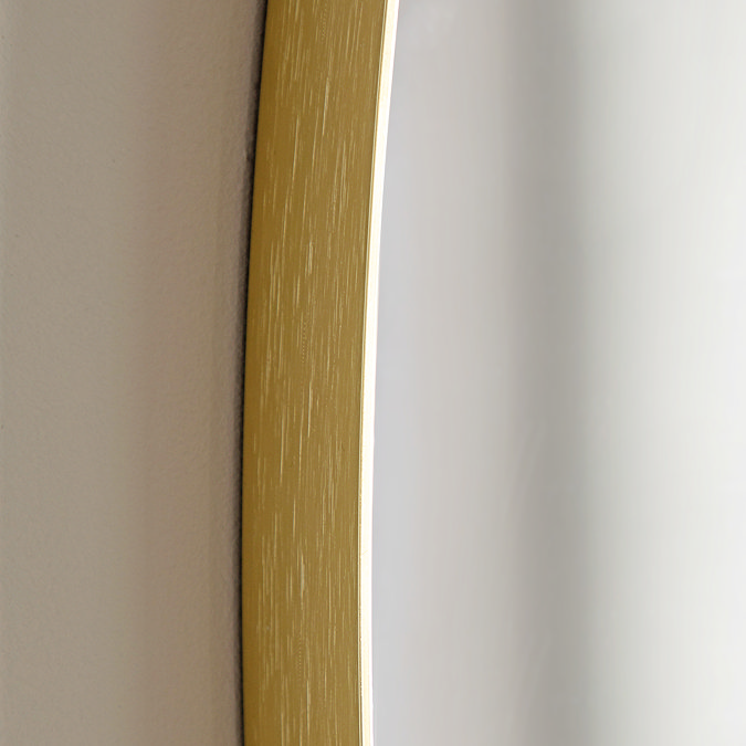 close up on smooth gold edge of pebble shaped wall mirror