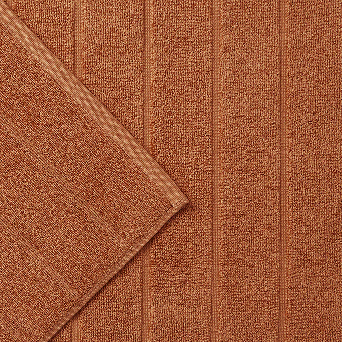 close up on texture of lined weave on amber bath mat
