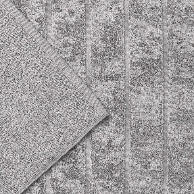 close up on wide ribbed texture of light grey cotton bath mat