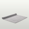 image of light grey bath mat slightly rolled up at end, on light grey background