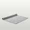image of light grey bath mat slightly rolled up at end, on light grey background