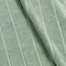close up on texture and colour of jade green cotton a bath mat with striped detailing