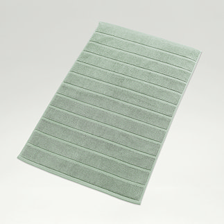 image of jade green bath mat on light grey background