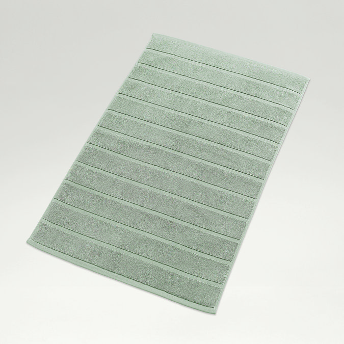 image of jade green bath mat on light grey background