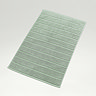 image of jade green bath mat on light grey background