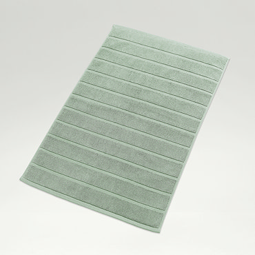 close up on texture and colour of jade green cotton a bath mat with striped detailing