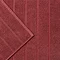 close up on wide ribbed texture of light red bath mat
