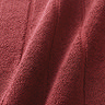 close up on colour and texture of light red bath mat