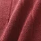 close up on colour and texture of light red bath mat