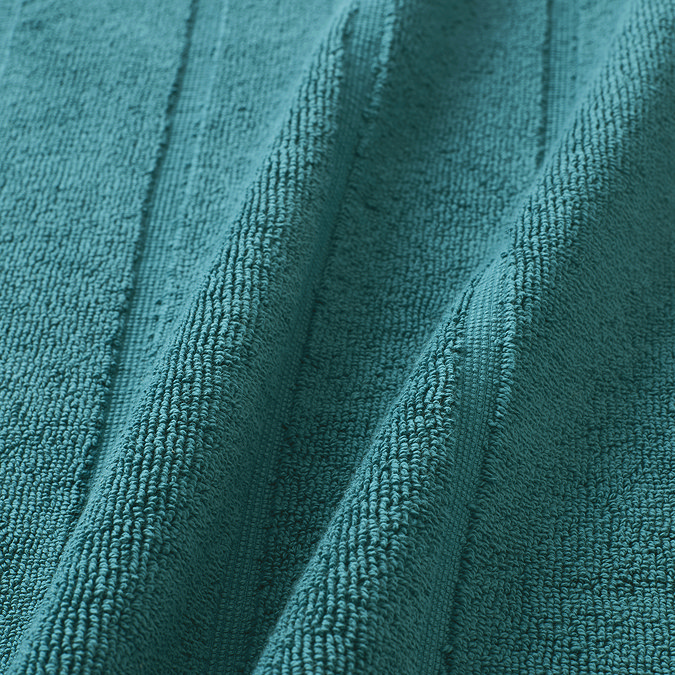 close up on texture and colour of teal blue bath mat