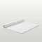 image of white bath mat rolled up on one end, on light grey background
