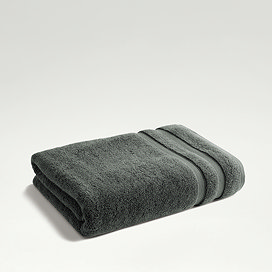 ash grey towel folded on light grey background