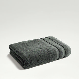 ash grey towel folded on light grey background