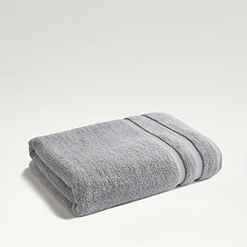 light grey towel folded on even lighter green background