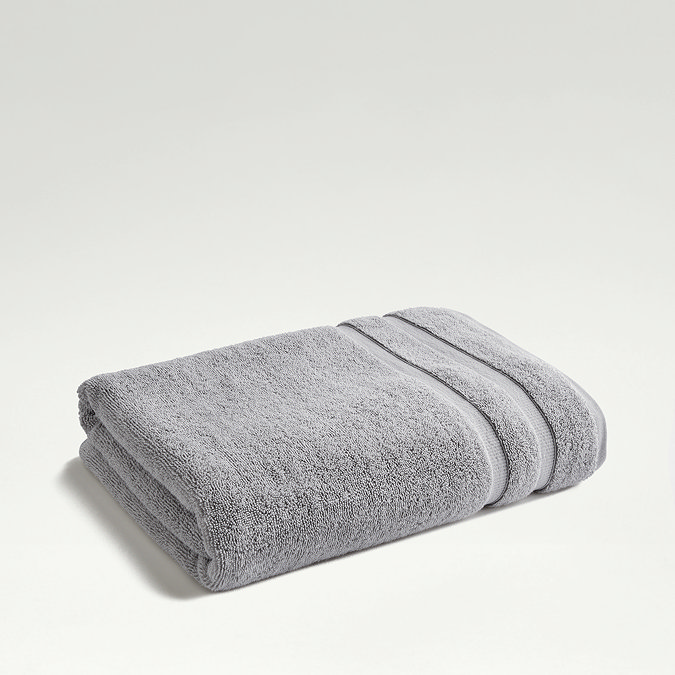light grey towel folded on even lighter green background