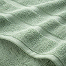 close up on border detail of jade green towels