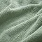 close up on texture and colour of jade green towels