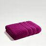 image of plum purple towel folded on light grey background