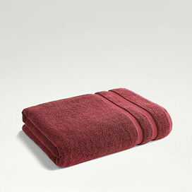 light red towel folded up on light grey background