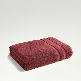 light red towel folded up on light grey background